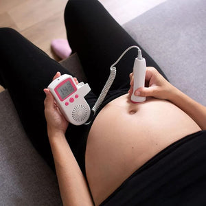 Pregnant mom use BabyEcho fetal doppler for at-home pregnancy bonding